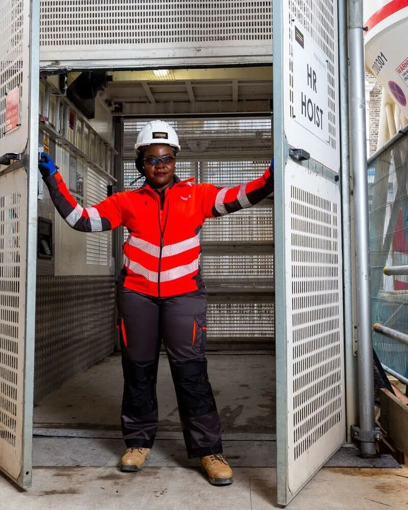 female wearing hi vis custom red jacket on construction site