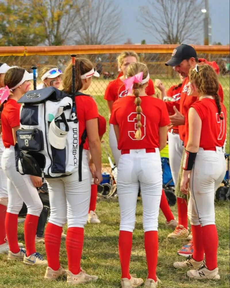 girls youth team wearing custom red and white bottom baseball uniforms
