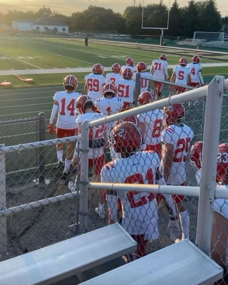 a local football team wearing white uniforms standing in playground