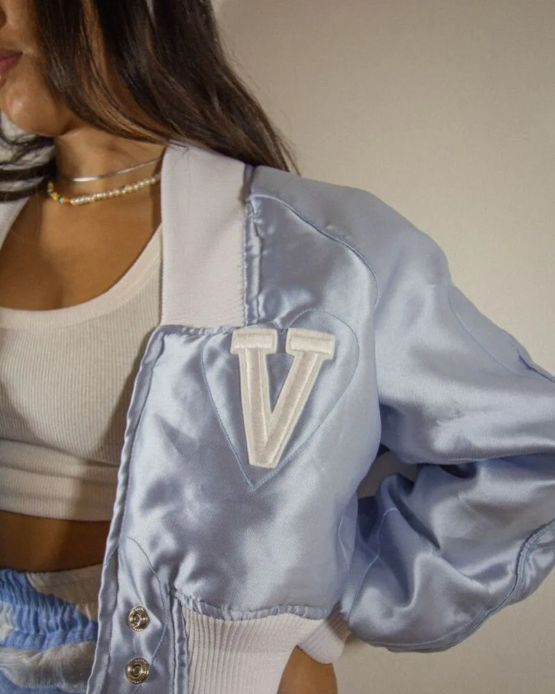 female wearing silver custom varsity jacket